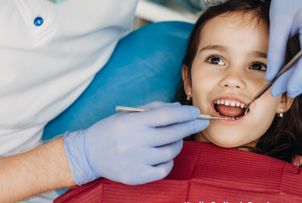 Young girl in dentist seat being examined