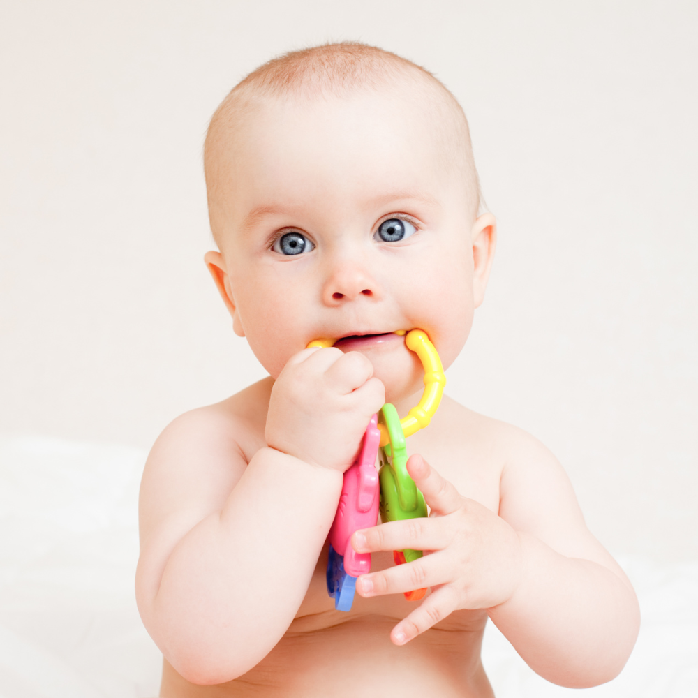 Baby chewing on teether toy.